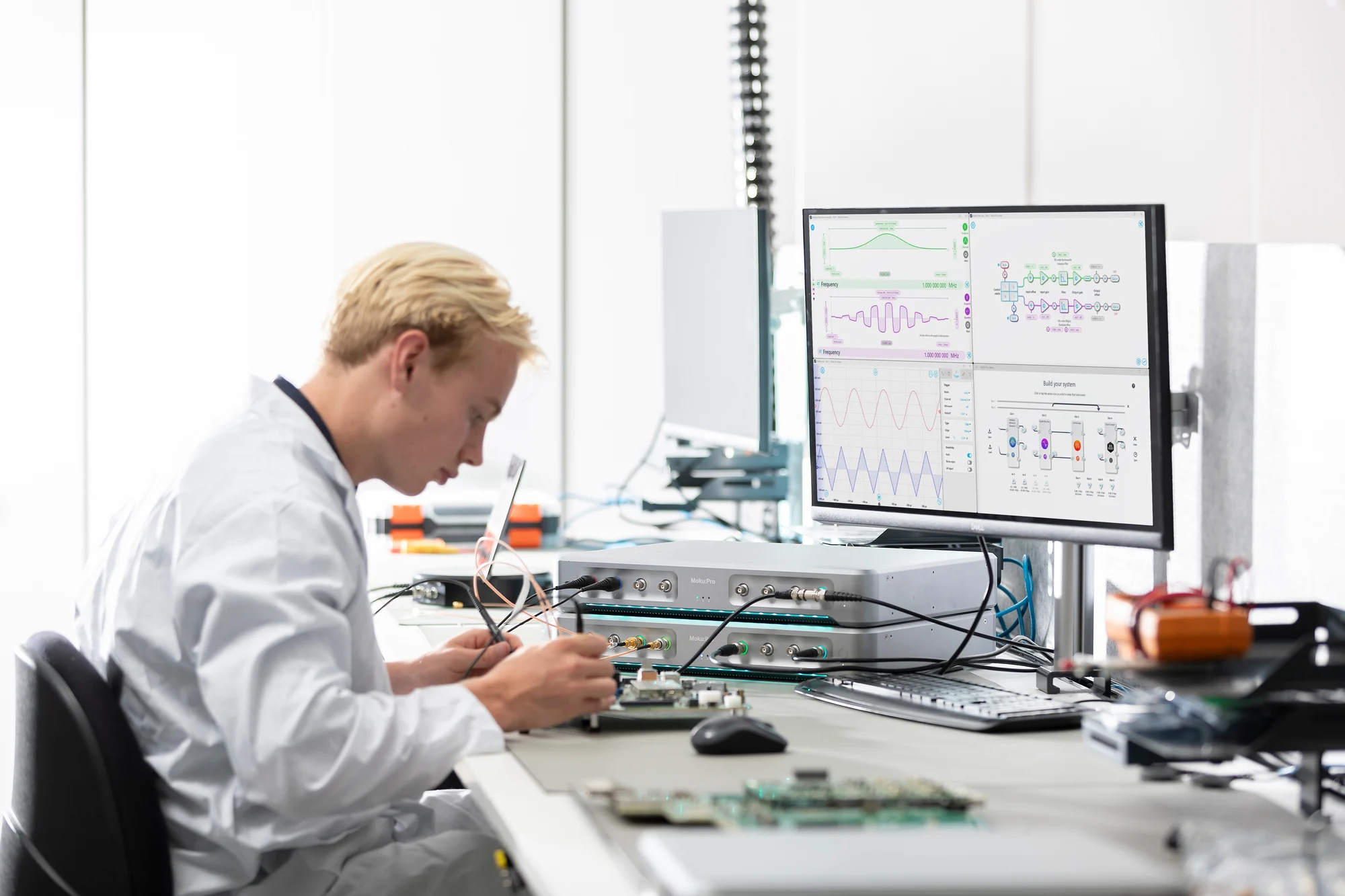 Engineer at desk conducting component testing with Moku:Pro
