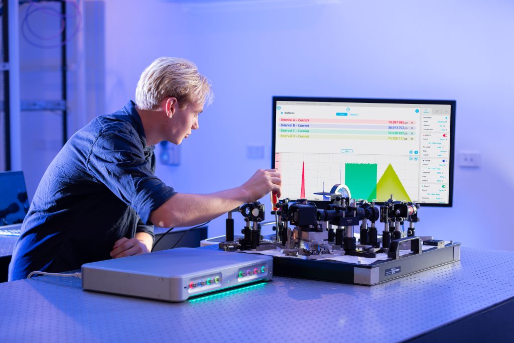 Scientist using the Moku Time and Frequency Analyzer