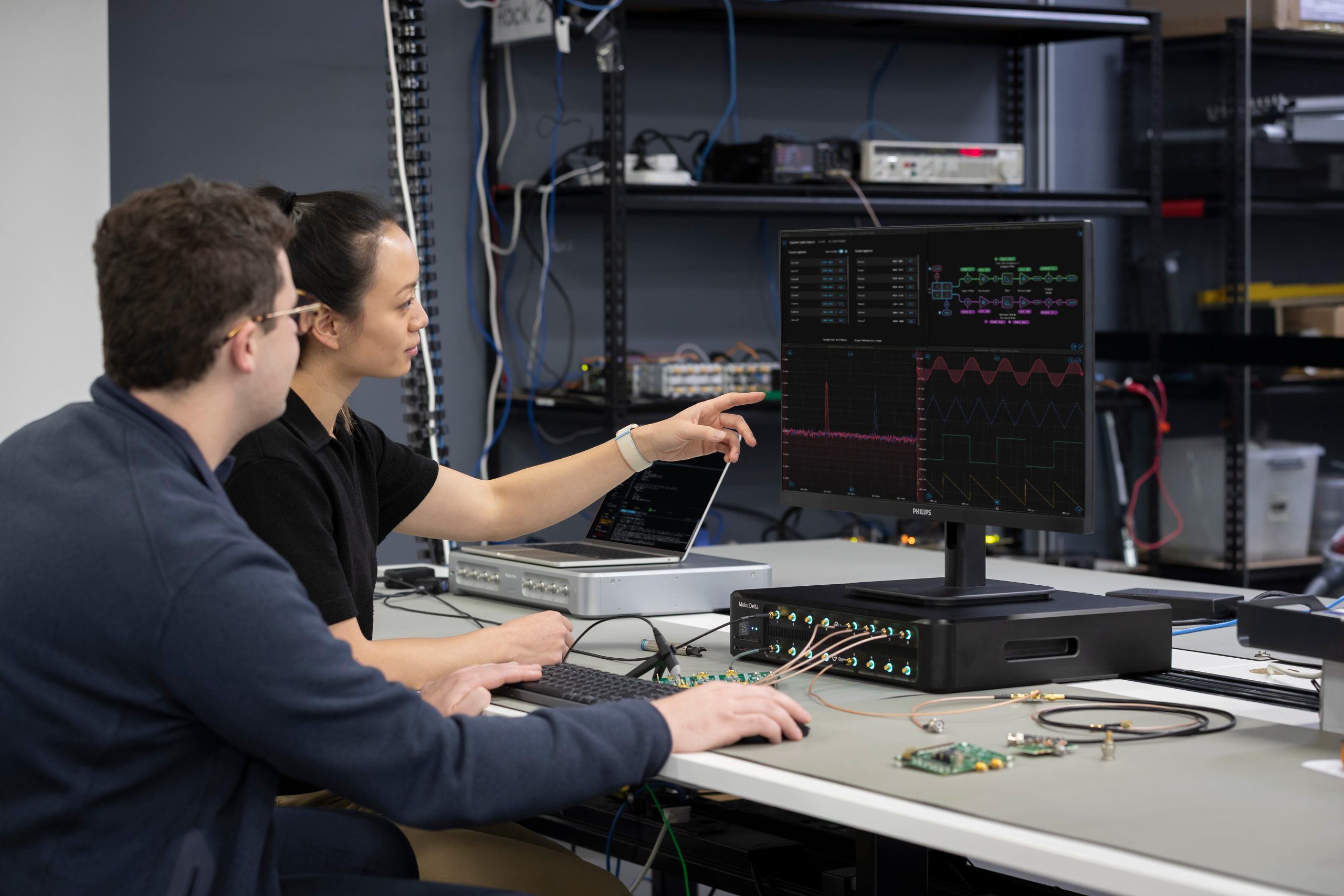 Engineers collaborating with reconfigurable test insturments.